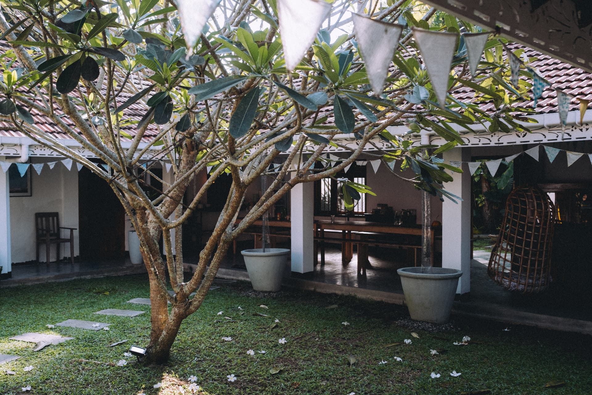 The retreat courtyard with frangipani trees and bunting