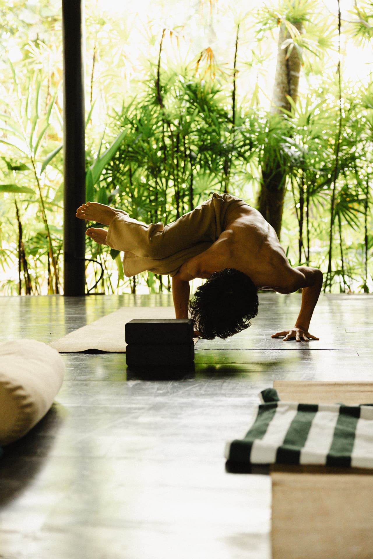 Yoga practitioner balancing in a bright jungle shala at a Sri Lanka yoga retreat