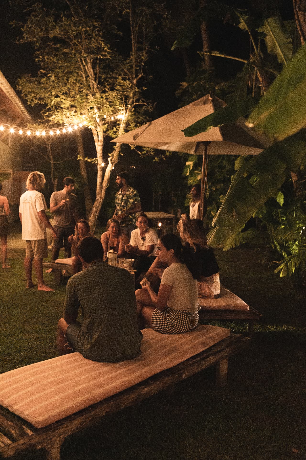 An evening gathering of guests in the villa garden