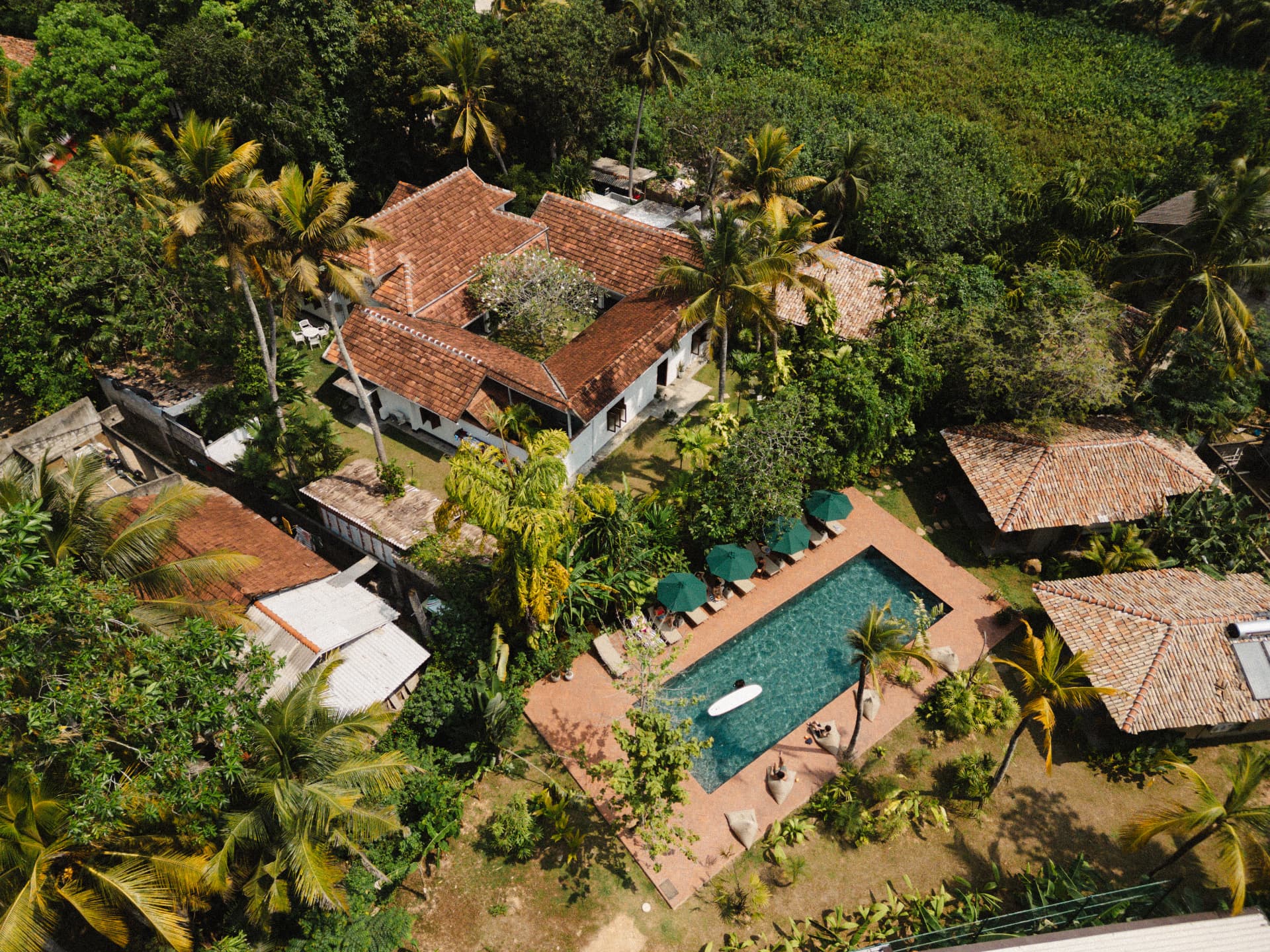 Aerial view of the colonial villa, pool and tropical gardens