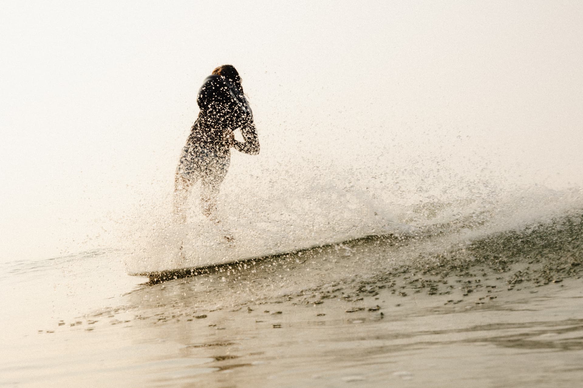 Surfer riding a wave at a surf camp break near Ahangama on the south coast of Sri Lanka