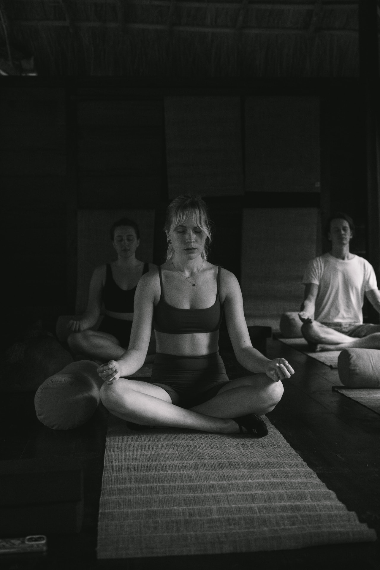 A guest meditating in the open-air yoga shala
