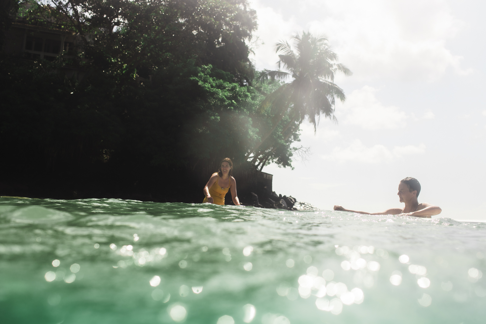 Two guests chatting in the turquoise water between waves