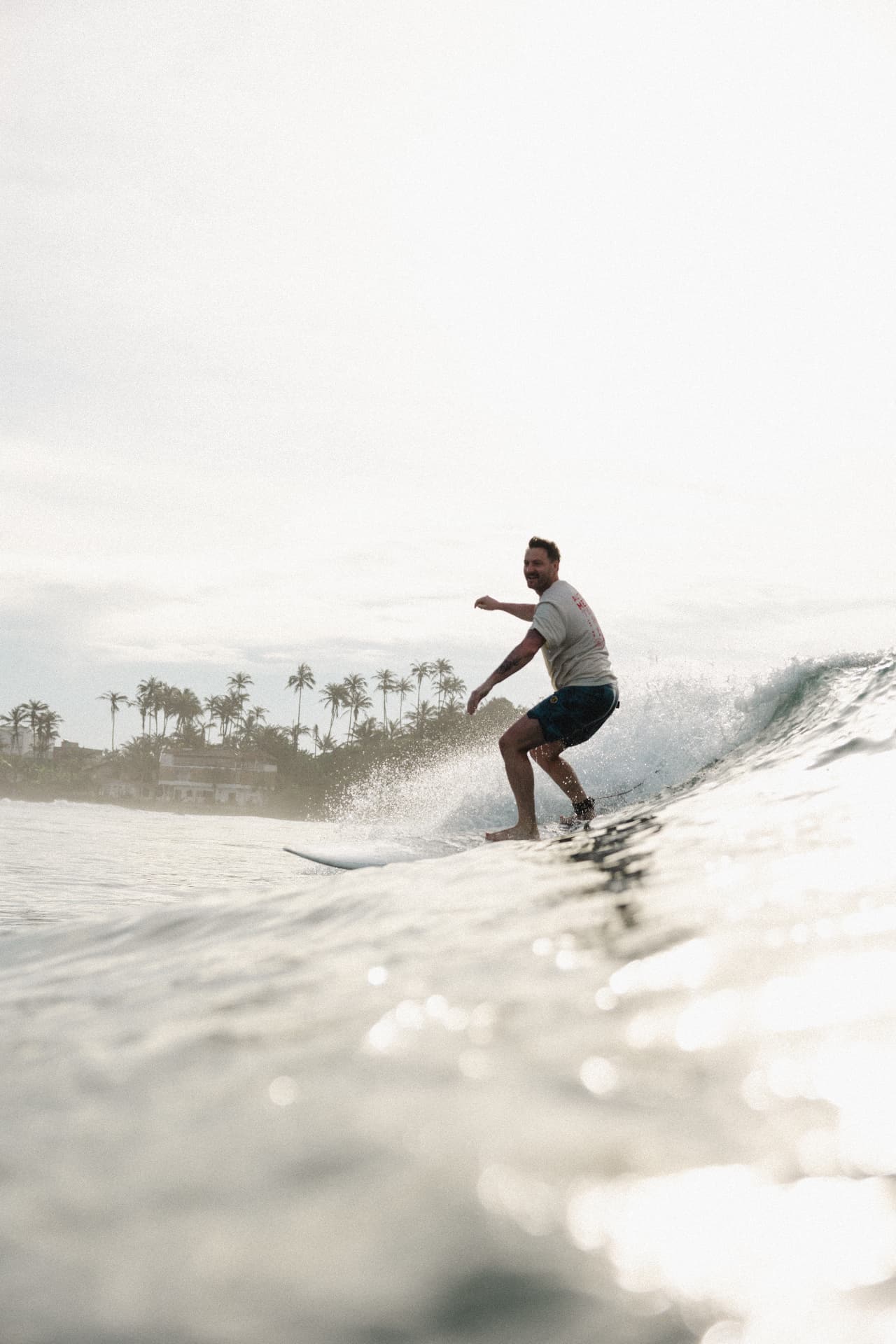 A guest gliding down the line on a clean wave