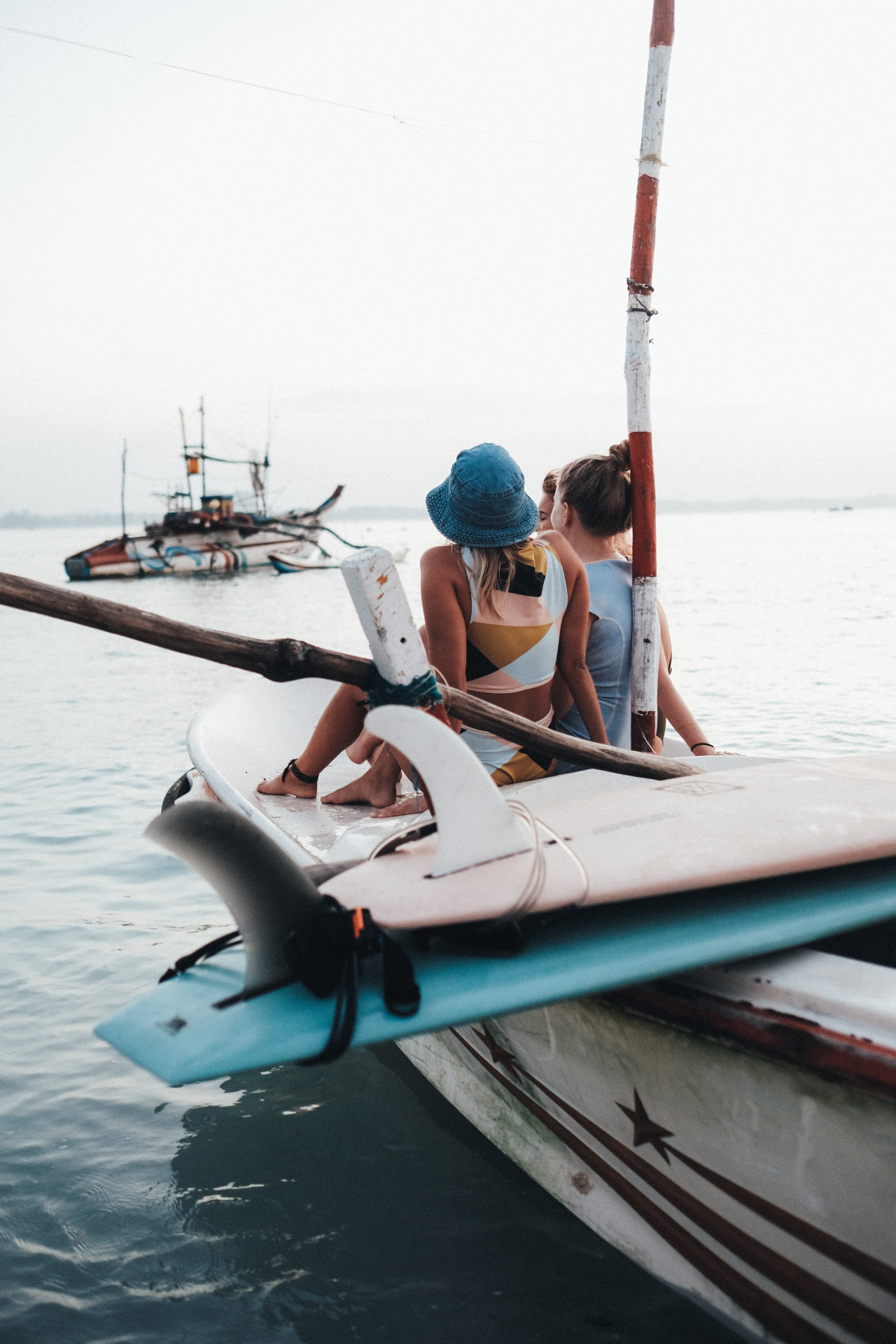 Surfers and boards on a traditional fishing boat heading to a Sri Lankan surf break