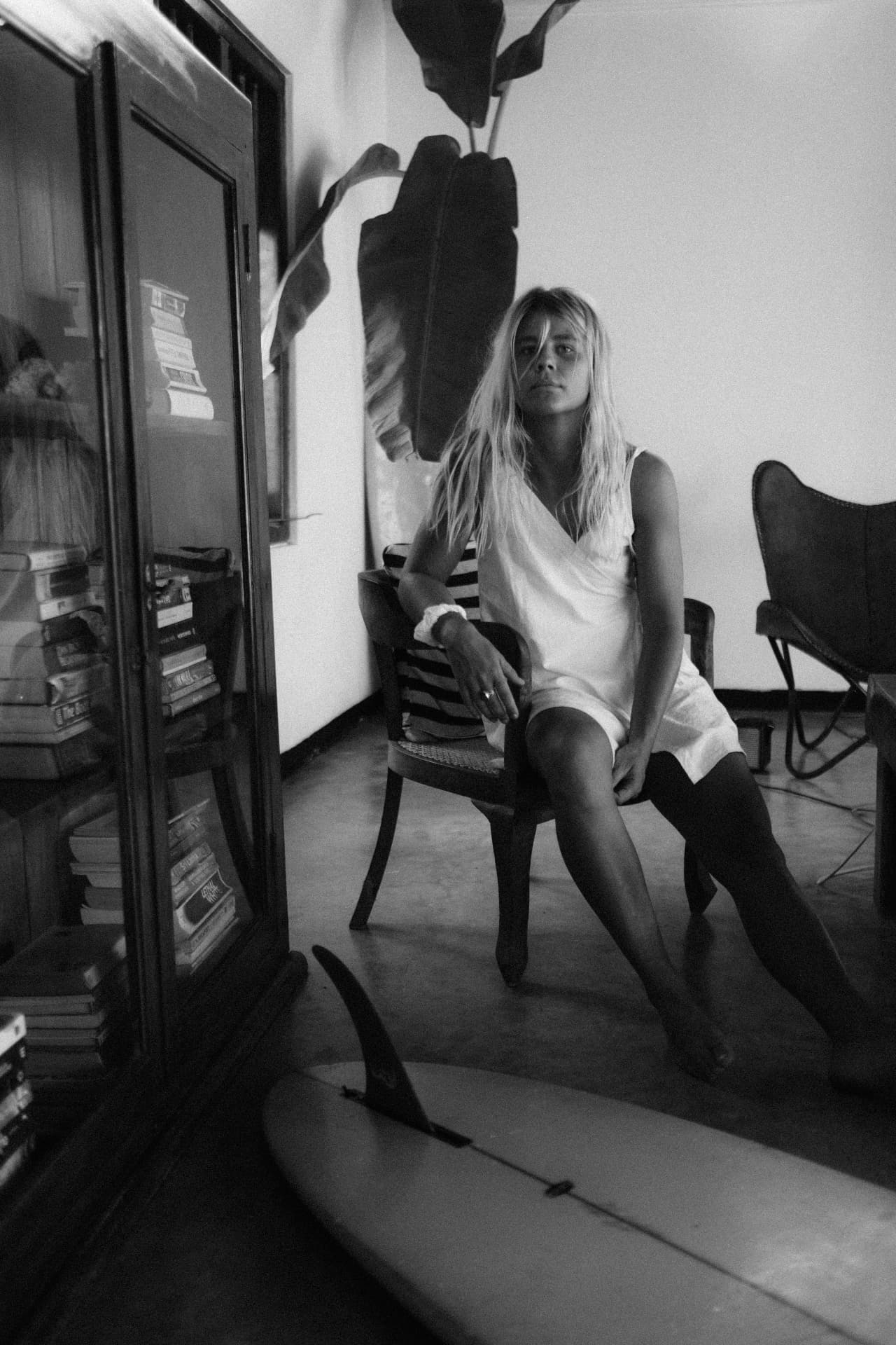 A black-and-white portrait in the villa living room beside a bookcase
